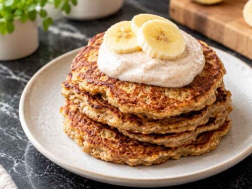 Babyfreundliche Bananen Pancakes mit Zimt-Joghurt, mehrere Stück auf einem Teller angerichtet